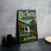 A vintage-style metal sign for DeSoto State Park in Alabama, featuring a scenic illustration of a waterfall and forest.