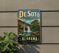 A vintage-style sign for DeSoto State Park in Alabama, featuring a waterfall and lush greenery.