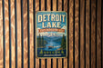 A vintage metal sign for Detroit Lake, Oregon, featuring a scenic mountain landscape with a lake and boats.
