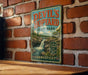 A vintage-style sign for Devil's Hopyard State Park in Connecticut, featuring a scenic image of a waterfall and lush greenery.