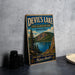 A vintage-style metal sign for Devil's Lake, Oregon, featuring a scenic landscape with a lake, mountains, and pine trees.