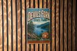 A vintage metal sign for Devil's Fork State Park, featuring a scenic landscape with a lake and mountains.