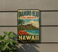 A vintage-style sign for Diamond Head State Monument in Hawaii, featuring a tropical landscape with palm trees, mountains, and a beach.