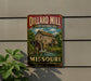A vintage metal sign for the Dillard Mill State Historic Site in Missouri, featuring an illustration of a wooden mill with a water wheel.