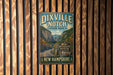 A vintage metal sign for Dixville Notch State Park in New Hampshire, featuring a scenic mountain landscape.