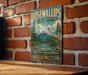 A vintage metal sign for Dosewallips State Park in Washington, featuring a scenic mountain landscape and a river.