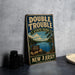 A vintage-style metal sign for Double Trouble State Park in New Jersey, featuring a scenic landscape with a lake and pine trees.