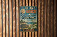 A vintage-style metal sign for St. George Island, Florida, featuring a portrait of a man and a scenic landscape.