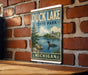 A vintage-style metal sign for Duck Lake State Park in Michigan, featuring a scenic illustration of a lake surrounded by trees and wildlife.