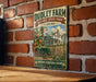 A vintage metal sign for Dudley Farm Historic State Park in Florida, featuring an illustration of a farm scene with a tractor and orange trees.