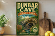 A vintage-style sign for Dunbar Cave State Park in Tennessee, featuring a scenic illustration of the cave and the surrounding nature.