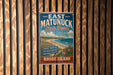 A vintage-style sign for East Matunuck State Beach, featuring a beach scene with a bird flying overhead and text indicating the location.