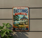 A vintage-style metal sign welcoming visitors to East Tawas City Park in Michigan, featuring a gazebo and a scenic landscape.