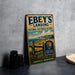 A vintage-style metal sign for the Ebey's Landing National Historical Reserve, featuring a scenic landscape with a wooden fence and a sign for Coupeville, Washington.