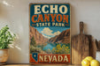 A vintage-style sign for Echo Canyon State Park in Nevada, featuring a scenic landscape with mountains, a lake, and a desert backdrop.