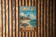 A vintage-style metal sign for Egmont Key State Park in Florida, featuring a lighthouse and beach scene.