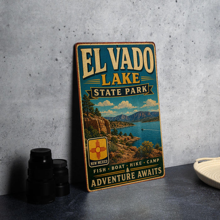 A vintage-style metal sign for El Vado Lake State Park, featuring a scenic landscape with mountains, a lake, and a boat, along with the text "El Vado Lake State Park" and "Adventure Awaits".