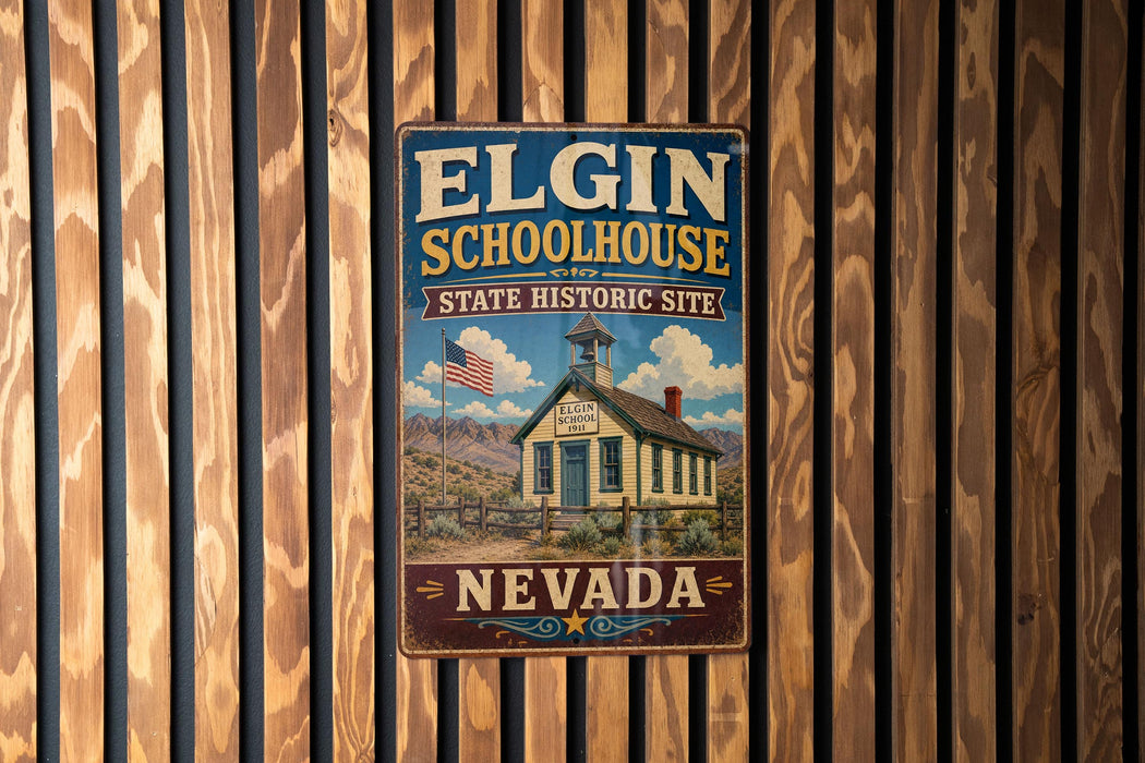 A vintage-style metal sign for Elgin Schoolhouse, a historic site in Nevada, is displayed on a wooden wall.