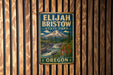 A vintage metal sign for Elijah Bristow State Park in Oregon, featuring a mountain landscape with a waterfall and pine trees.