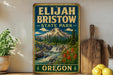 A vintage-style metal sign for Elijah Bristow State Park in Oregon, featuring a mountain landscape with a waterfall and pine trees.