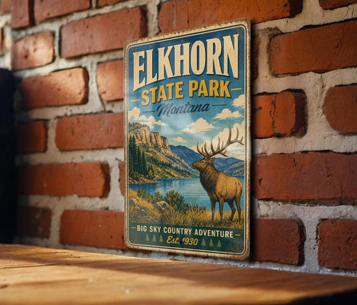 A vintage-style metal sign for Elkhorn State Park in Montana, featuring an illustration of a deer in a mountainous landscape.