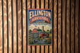 A vintage-style metal sign for the Ellington Agricultural Center in Tennessee, featuring a farm scene with a tractor and barn.