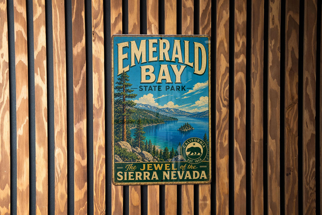 A vintage-style metal sign for Emerald Bay State Park, featuring a scenic landscape with a lake, mountains, and a small island.