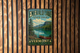 A vintage-style metal sign for Emerald Lake State Park in Vermont, featuring a scenic landscape with a lake, mountains, and a canoe.