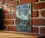 a vintage metal sign for the Fall River Heritage State Park in Massachusetts, mounted on a brick wall.