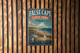 a vintage-style metal sign for False Cape State Park, Virginia, mounted on a wooden wall.