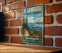 A vintage metal sign for Fay Babinbridge State Park, featuring a scenic image of a boat on a lake surrounded by pine trees and mountains.