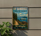 A vintage-style sign for Fay Babinbridge State Park, featuring a scenic image of a path leading to a picnic area with a boat on the water.
