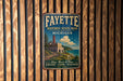 A vintage-style metal sign for Fayette Historic State Park in Michigan, featuring a scenic illustration of a coastal landscape with a lighthouse and a castle.