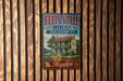 A vintage-style metal sign for the Felix Valle House, a historic site in Missouri, is displayed on a wooden wall.