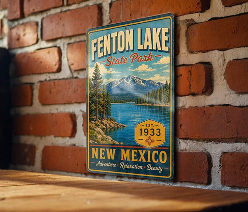 A vintage-style metal sign for Fenton Lake State Park in New Mexico, featuring a scenic landscape with mountains, trees, and a lake.