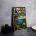 A vintage-style metal sign for Finger Lakes State Park in Missouri, featuring a scenic landscape with a lake and mountains.