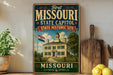 A vintage-style sign for the First Missouri State Capitol, featuring an illustration of a historic building and the text "First Missouri State Capitol State Historic Site" and "Missouri".