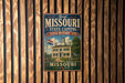 A vintage-style metal sign that reads "First Missouri State Capitol State Historic Site" with an illustration of a historic building.