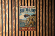 A vintage metal sign for Buffalo Jump State Park in Montana, featuring an illustration of a buffalo jumping over a cliff.