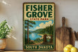 A vintage-style sign for Fisher Grove State Park in South Dakota, featuring a scenic landscape with pine trees, a lake, and mountains.