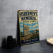 a vintage metal sign for Fishermen's Memorial State Park, with a lighthouse and a monument in the background.