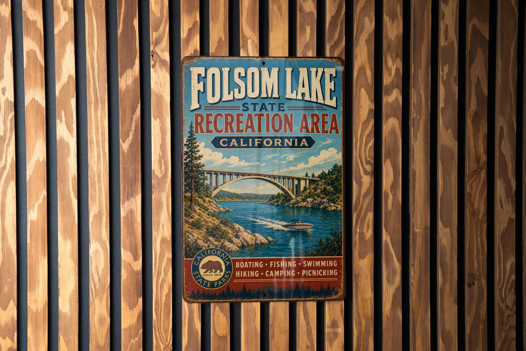 A vintage metal sign for Folsom Lake State Recreation Area in California, featuring a scenic illustration of the lake and a bridge.