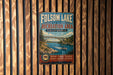 A vintage metal sign for Folsom Lake State Recreation Area in California, featuring a scenic illustration of the lake and a bridge.
