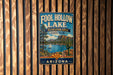 A vintage-style sign for Foolhole Lake, a recreation area in Arizona State Park, featuring a scenic landscape with a lake, mountains, and a sailboat.
