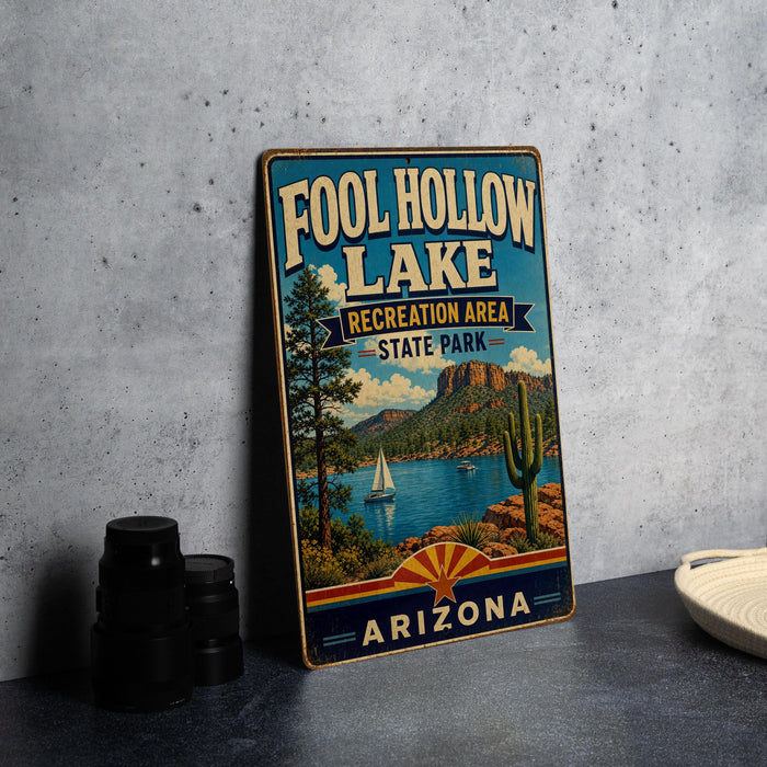 A vintage-style sign for Foolhole Lake, a recreation area in Arizona State Park, featuring a scenic landscape with a lake, mountains, and a sailboat.