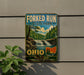 A vintage-style sign for Forked Run State Park in Ohio, featuring a scenic landscape with a waterfall and forest.