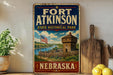 A vintage-style metal sign for Fort Atkinson State Historical Park in Nebraska, featuring an illustration of a historic fort and surrounding landscape.