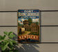 A vintage-style sign for Fort Boone, Kentucky State Park, featuring an illustration of a historical fort and a wagon, mounted on a wall.