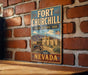 A vintage-style metal sign for Fort Churchill, a historic park in Nevada, featuring an illustration of a historic building and a cannon.