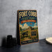 A vintage-style metal sign for Fort Cobb State Park in Oklahoma, featuring an illustration of a cannon and a sign that reads "Fort Cobb State Park - Oklahoma".